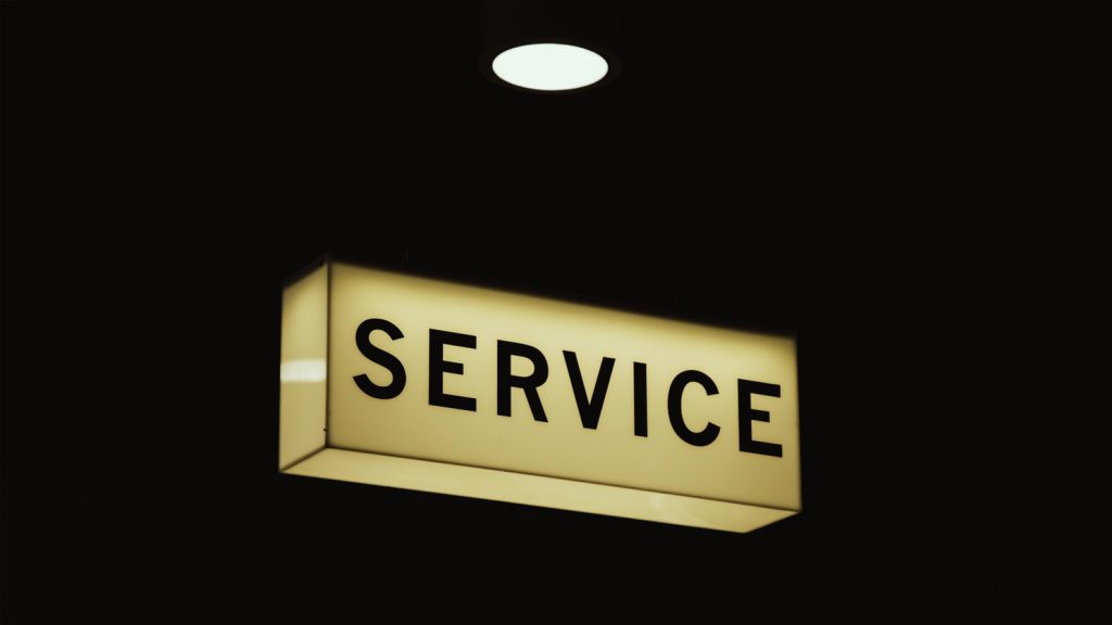 A light box displaying the word 'service' with a spot light shining down onto it.